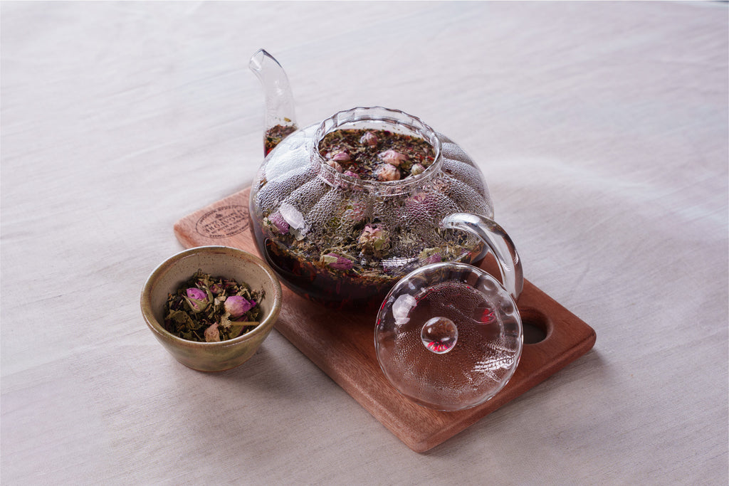 Lavara Botanics herbal blend tea infusion in a transparent pot